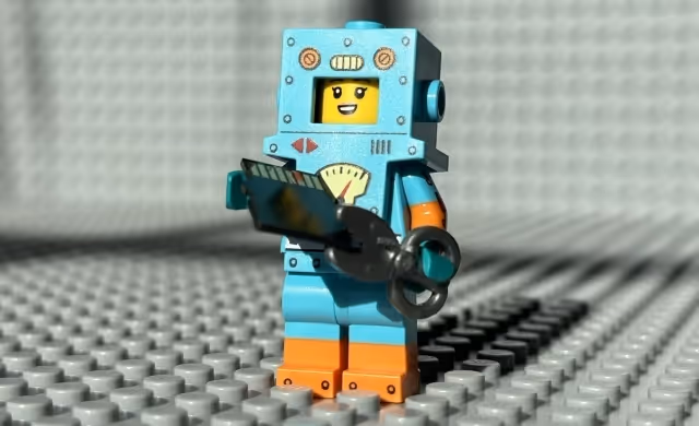 Photo of a LEGO minifigure using a scissor to destroy a microSD card.