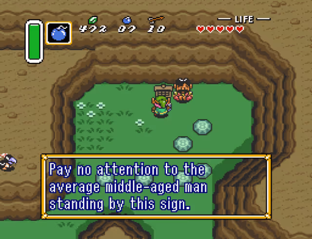 Screenshot from The Legend of Zelda: A Link to the Past. Pay no attention to the average middle-aged man standing by this sign.
